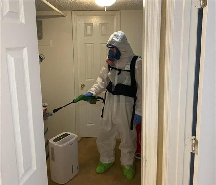 SERVPRO technicians with protective clothing in home