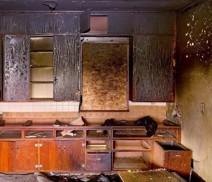 Fire damaged kitchen; charred cabinets; smoke damage