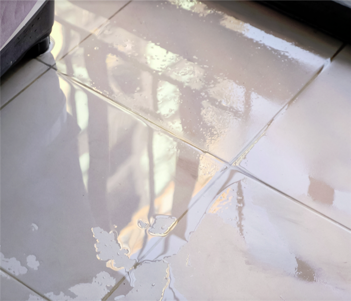 a puddle of water on tile floor