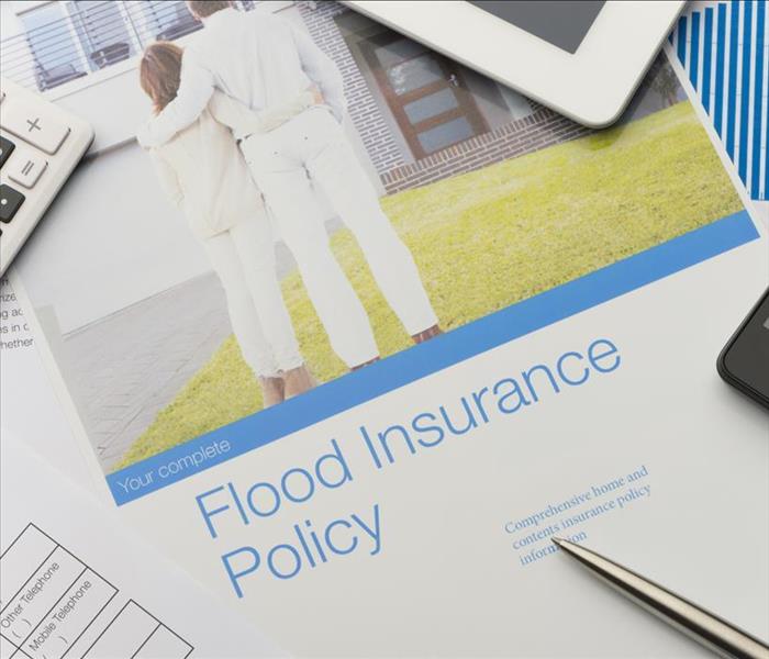 pic couple and flood insurance policy on paper